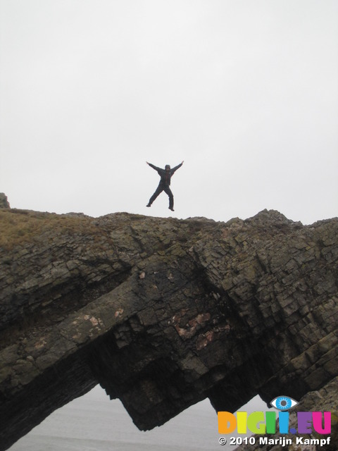 SX13376 Marijn jumping on Devil's bridge at Worms head